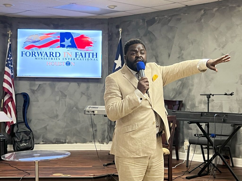 Pastor Masimba Vilika preaching on stage at FIF Houston.